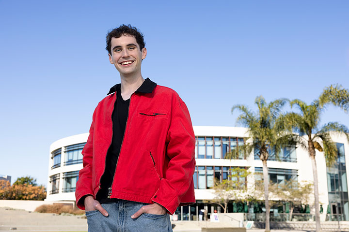 Gavin Butts standing in front of the William H Hannon Library