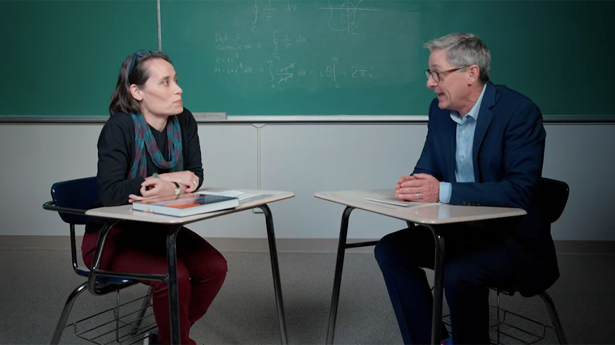 Lily Khadjavi and Presides Timothy Law Snyder sitting in a classroom and talking